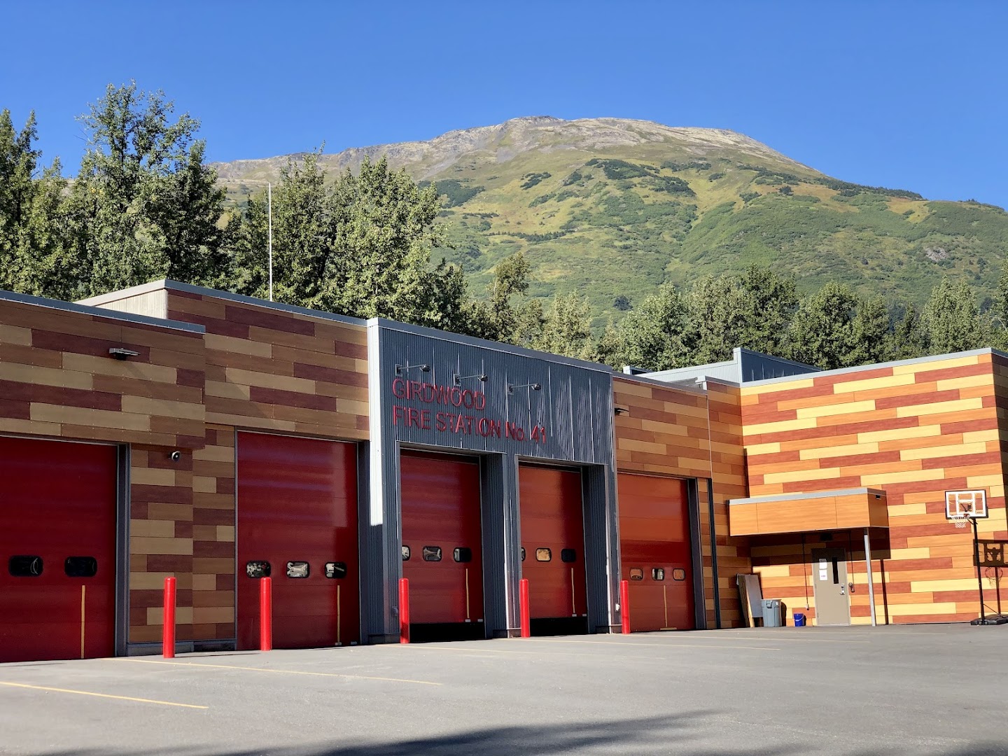 Fire engine with emergency lights at base of snow-covered Alaska mountains